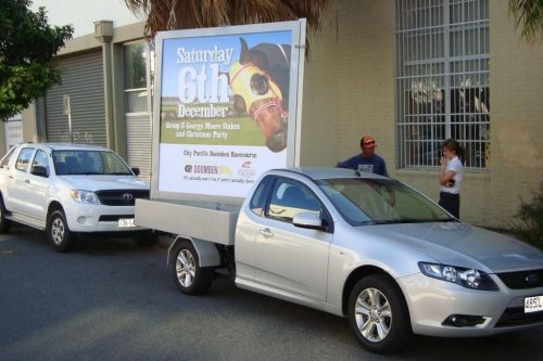 car-carrying-big-poster-at-the-back